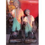 A pair of cast iron blackamoor type figures