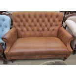 A Brown leather two seater settee with button back upholstery