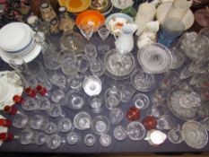 A large collection of drinking glasses, pottery jugs,