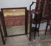 A mahogany folding cake stand together with a triptych mirror