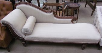 A Victorian oak framed chaise longue with leaf decoration and cream upholstery