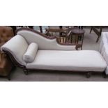 A Victorian oak framed chaise longue with leaf decoration and cream upholstery