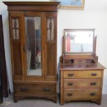 An Edwardian walnut two piece bedroom suite comprising a single door wardrobe and matching dressing