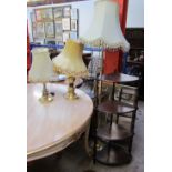 A brass standard lamp together with two brass table lamps,