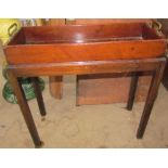 A George III mahogany plant trough and stand of rectangular form, with brass handles,
