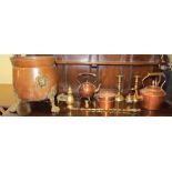 A copper coal box on brass feet together with copper kettles,