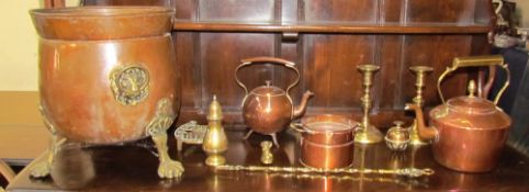 A copper coal box on brass feet together with copper kettles,