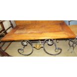 A 20th century coffee table with a scrolling cast iron and brass base