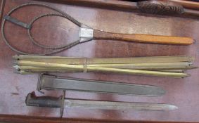 A World War II US 1942 bayonet and scabbard together with brass stair rods and a Kindly carpet