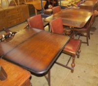 An oak extending dining table together with a set of four dining chairs, a sideboard,