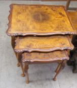 A 20th century walnut nest of three tables