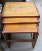 A teak nest of three tables stamped 000127