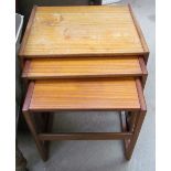 A teak nest of three tables stamped 000127