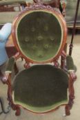 A Victorian walnut framed child's elbow chair with a varied back and scrolling legs