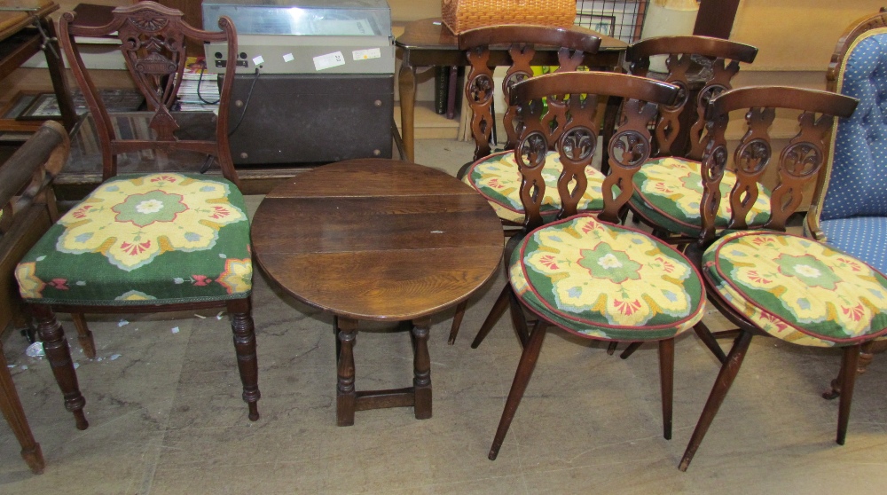 A set of four wheel back dining chairs together with a small oak coffee table and a nursing chair