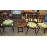 A set of four wheel back dining chairs together with a small oak coffee table and a nursing chair