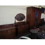 An Edwardian mahogany matched three piece bedroom suite comprising a triple wardrobe,
