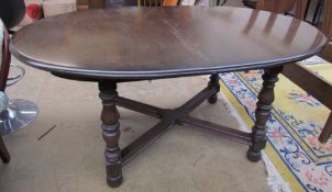 An Ercol dark elm extending dining table