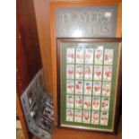 Two albums of cigarette cards together with framed cigarette cards