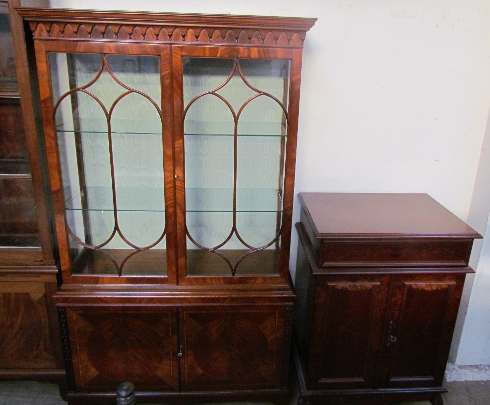 A 20th century mahogany bookcase with a moulded cornice above a pair of glazed doors,