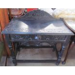 A 19th century ebonised low countries side table with a single drawer and lions mask handle on