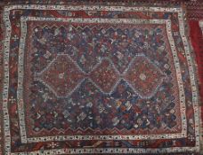 A Shiraz rug, the indigo field with triple serrated pole medallion,