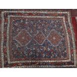 A Shiraz rug, the indigo field with triple serrated pole medallion,