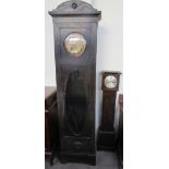 An early 20th ebonised oak long case clock, with a stamped brass dial and Arabic numerals,