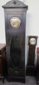 An early 20th ebonised oak long case clock, with a stamped brass dial and Arabic numerals,