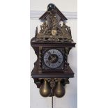 A Dutch wall clock with a cast brass decoration and brass weights