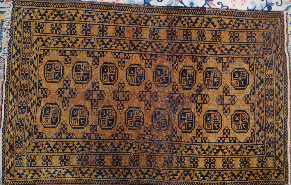 A Turkoman rug with multiple guls to an orange ground