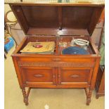 A Gilbert oak cased gramophone together with a collection of 78 records