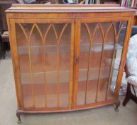 A 20th century walnut display cabinet together with a set of three bar stools