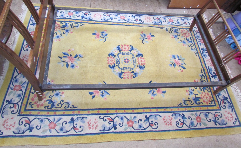 A Chinese rug, yellow field with central medallion in ivory foliate main border, - Image 2 of 2