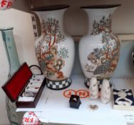 A large glass vase together with pottery vases,