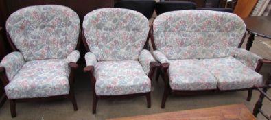 A modern three piece suite with a wooden frame