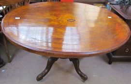 A Victorian walnut supper table of oval form on four legs