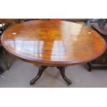 A Victorian walnut supper table of oval form on four legs