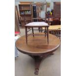 A Victorian mahogany supper table with a circular top and octagonal column and trefoil base and