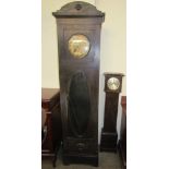 An early 20th ebonised oak long case clock, with a stamped brass dial and Arabic numerals,