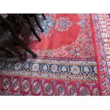 A room size rug with an orange ground,