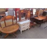A circular coffee table together with two dressing table mirrors, a white painted chest of drawers,