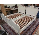 A pair of white painted French style single beds