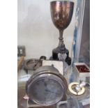 A silver trophy cup together with a Smiths dashboard clock, rattle,