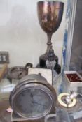 A silver trophy cup together with a Smiths dashboard clock, rattle,