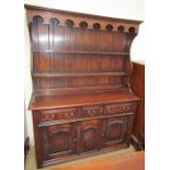 A reproduction oak dining suite including a North Wales style dresser,
