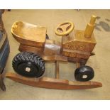 A child's carved wooden rocking tractor