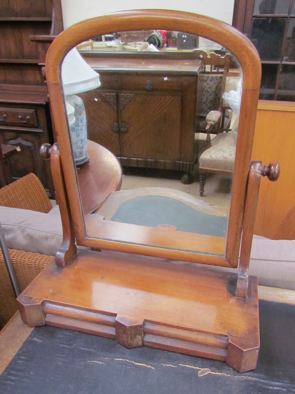 A Victorian mahogany toilet mirror with a domed mirror and two base drawers