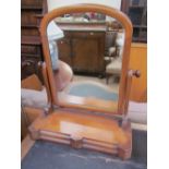 A Victorian mahogany toilet mirror with a domed mirror and two base drawers