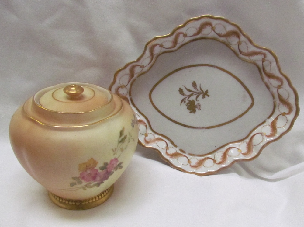 A Royal Worcester porcelain lobed jar and cover decorated worth flowers and leaves together with a